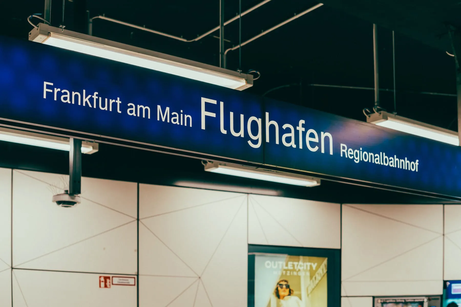 The "Frankfurt am Main Flughafen Regionalbahnhof" sign in the station beneath the terminal — Frankfurt Airport Transfer (FRA)