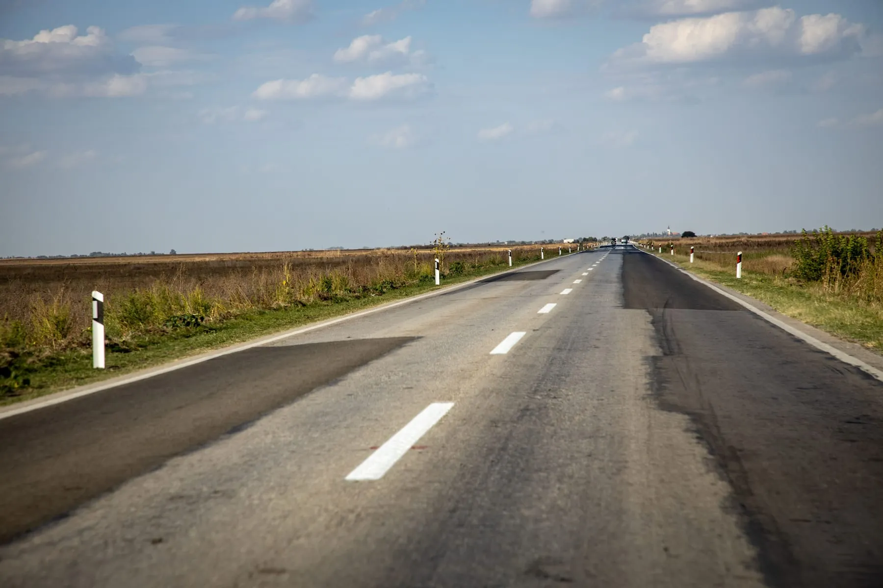 An empty country road stretching into the distance — Custom Private Journeys by Chauffeur, Frankfurt