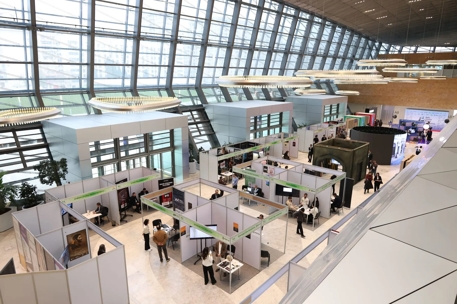 An exhibition hall of stands beneath a glass roof — Messe Frankfurt Chauffeur & Trade Fair Transfers