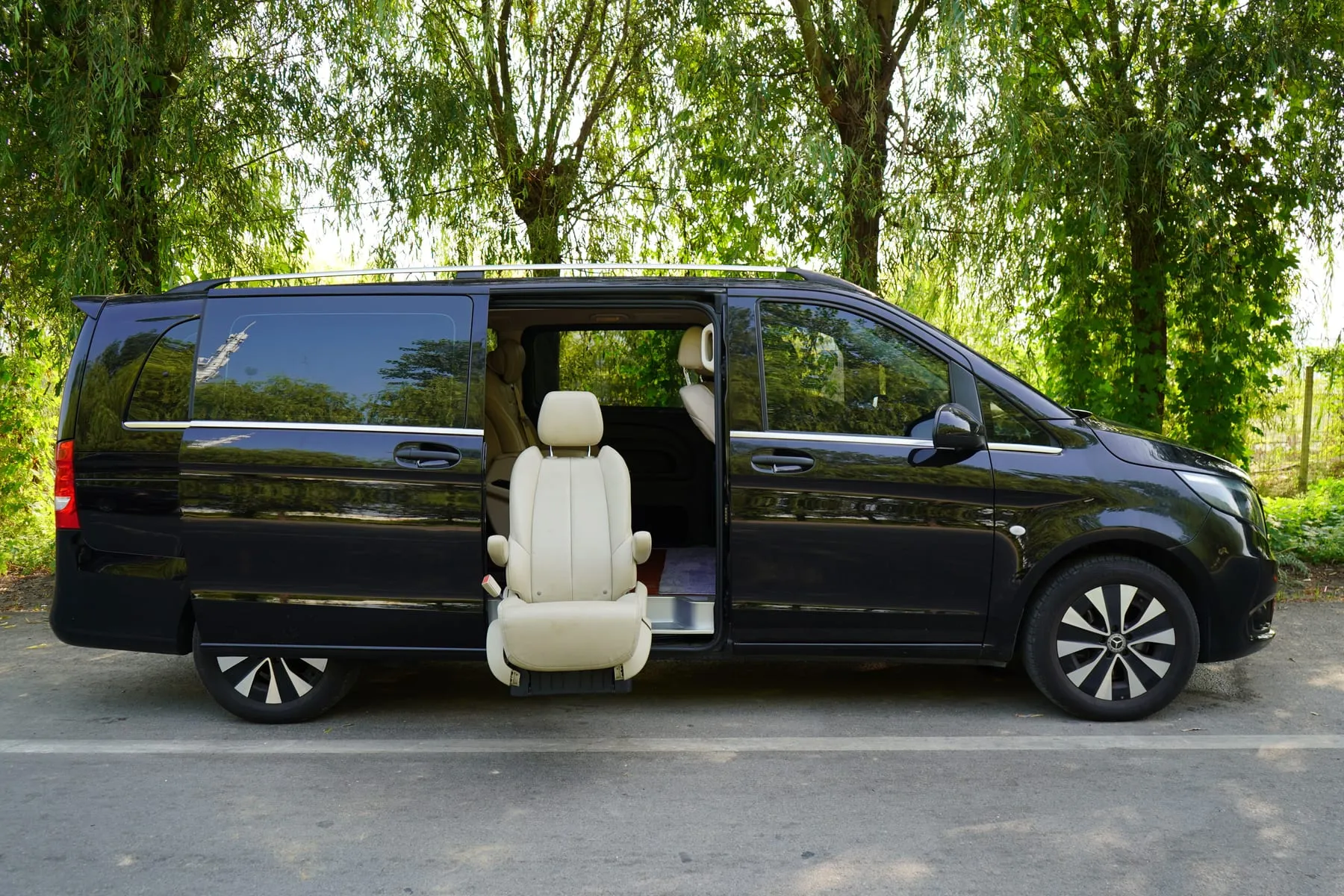 A black Mercedes-Benz van with its side door open on a city street — Group Airport Transfer Frankfurt — Vans & Multiple Vehicles