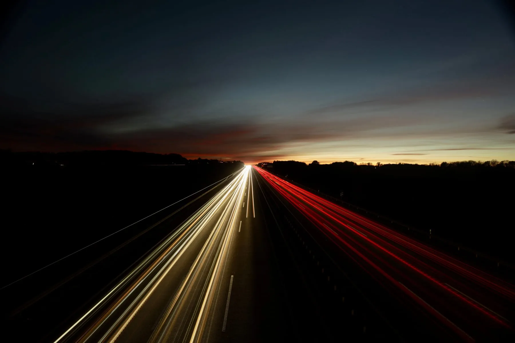 Light trails along a motorway at dusk — Intercity Chauffeur Service from Frankfurt