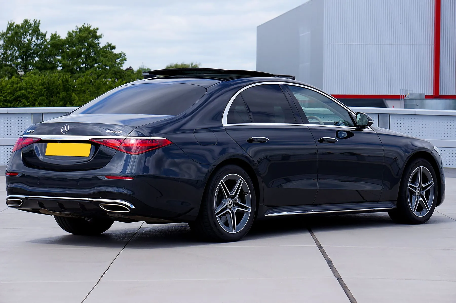 A black Mercedes-Benz saloon parked in a modern urban setting — Luxury Chauffeur Service Frankfurt — Premium Private Car